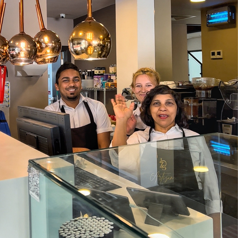 Three Little Dessert Shop staff members standing behind the till in the Reading restaurant