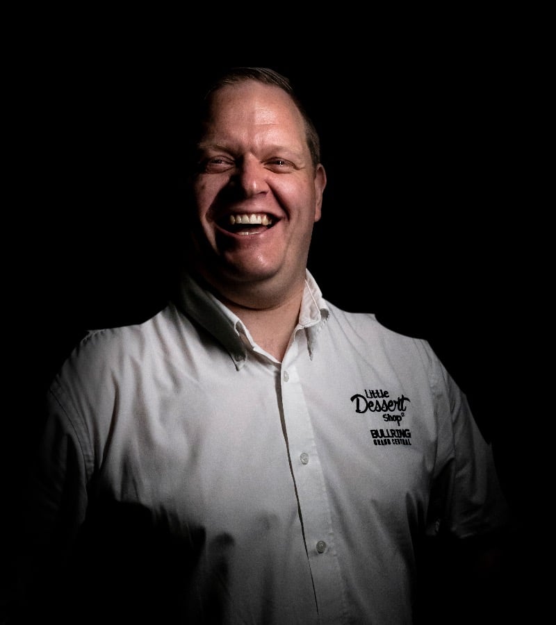 Little Dessert Shop Franchisee Dean Haynes smiling whilst wearing a Little Dessert Shop branded shirt