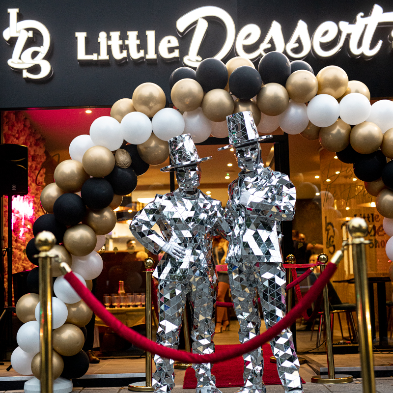 Little Dessert Shop Store opening with white gold and black balloon arch, mirror men at the front.